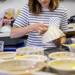 Alice Funge applying transfers to some mixing bowls 2019
